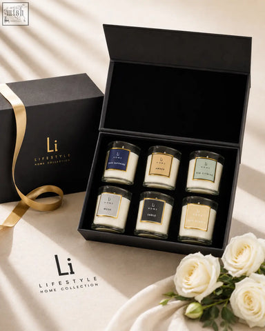 Six glass scented candles with color-coded tags in a black box from a candle discovery set perfect for gifting