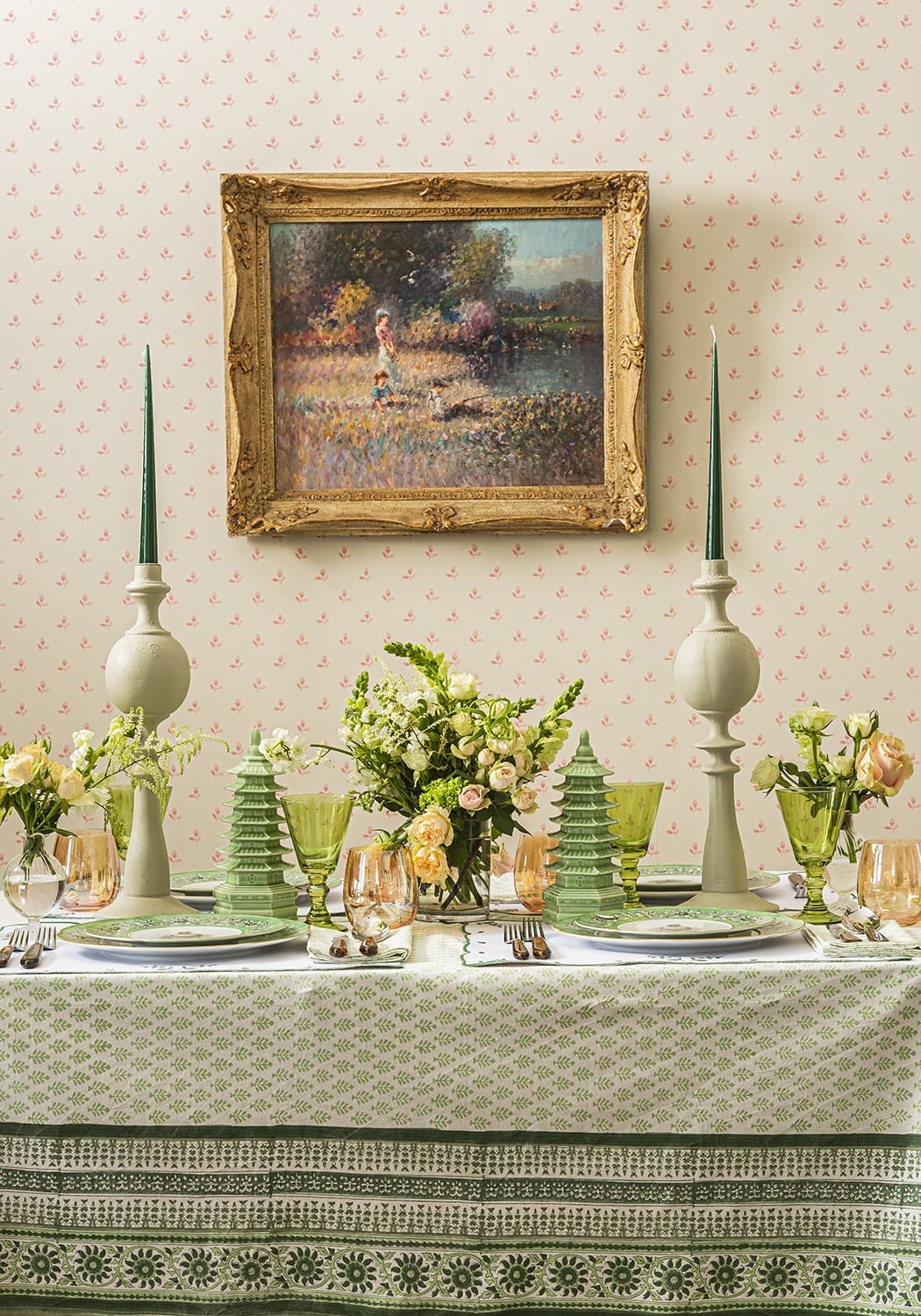 Green glass candlesticks with slender tapered tops and bulbous bases for elegant candle lighting