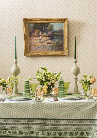 Green glass candlesticks with slender tapered tops and bulbous bases for elegant candle lighting