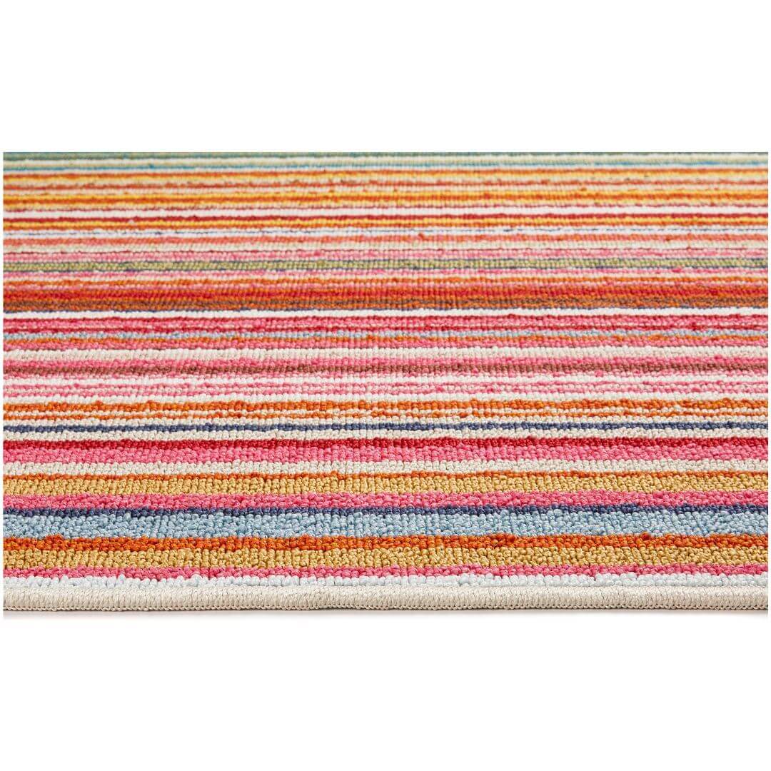 A colorful candy washable runner rug with pink orange red blue and white stripes perfect for easy cleaning