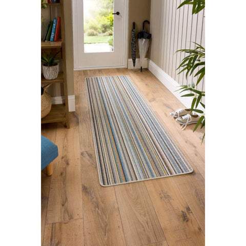 Candy washable runner stripe design with textured weave in blue gray beige and white on wooden floor