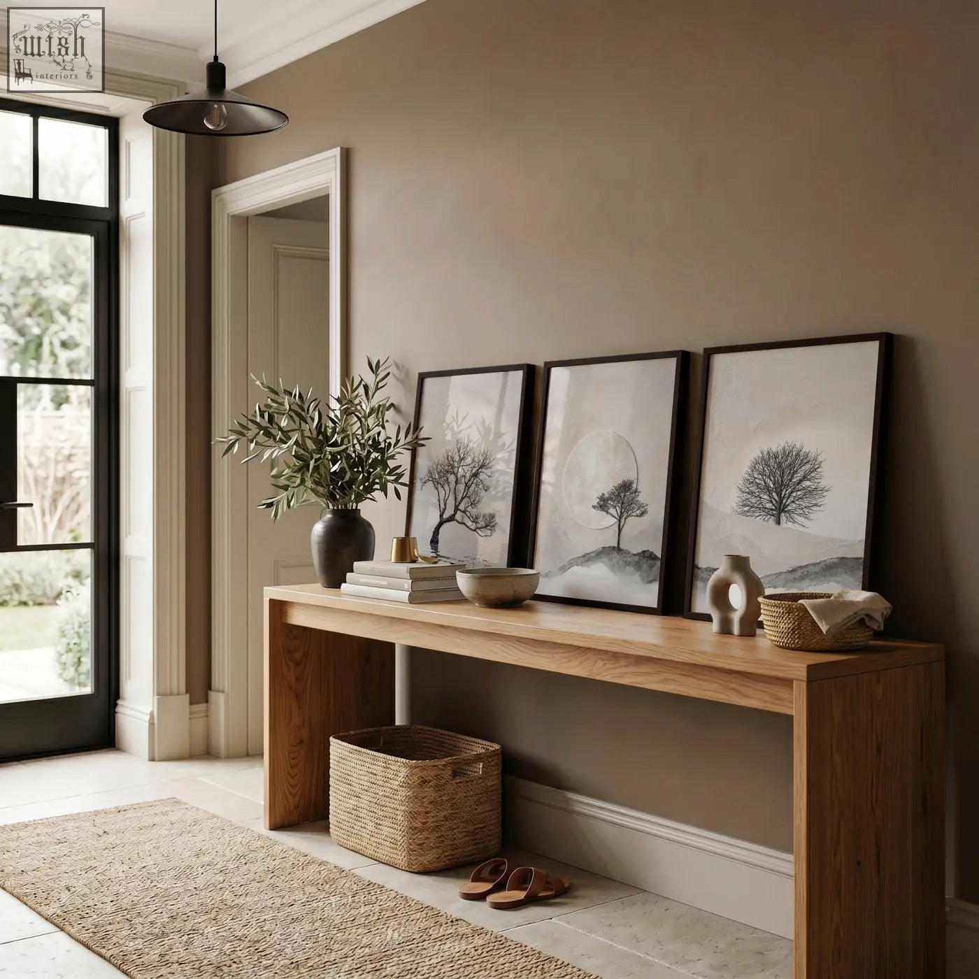 A minimalist wooden console table with natural finish and clean lines below canvas art landscape scandi nordic trees prints set of 3