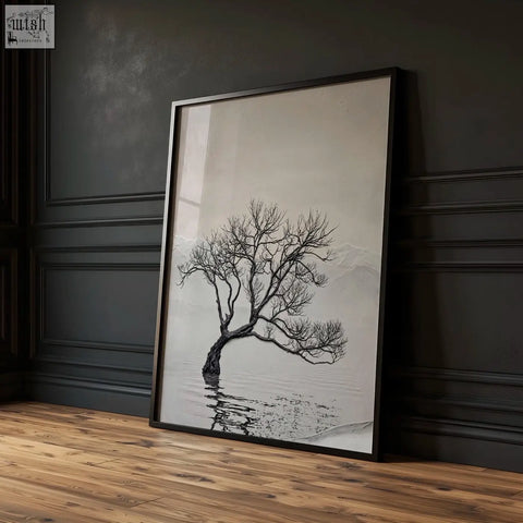 Black-framed canvas art landscape featuring a minimalist leafless tree with intricate branches over water in soft gradient background