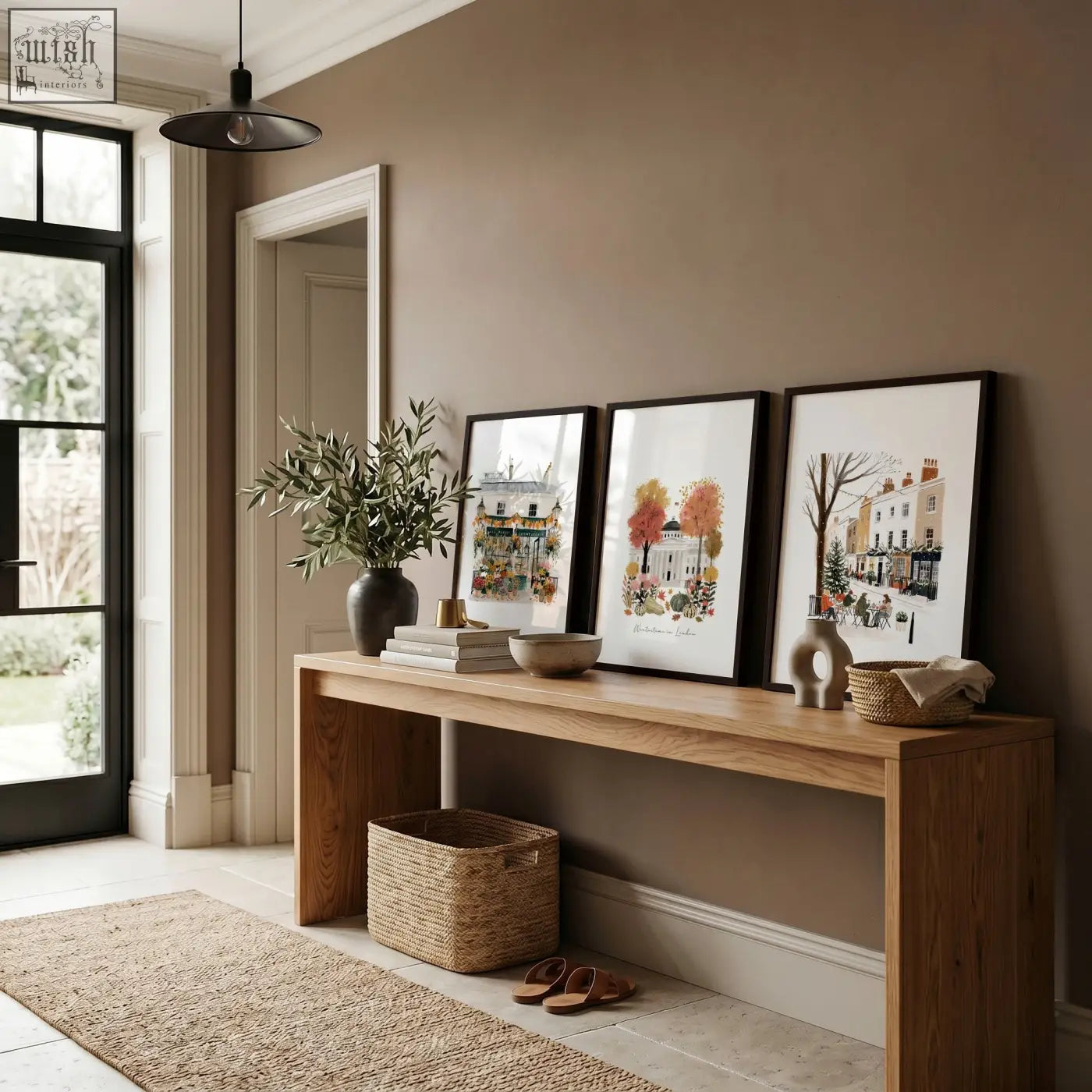 A minimalist wooden console table with natural finish and clean lines paired with covent garden london travel wall art prints