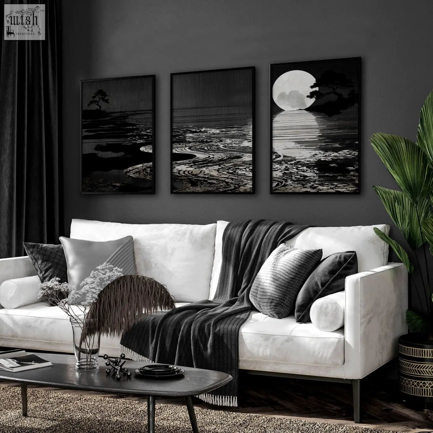 White sofa with black and gray pillows and dark gray blanket in living room featuring deep charcoal canvas pictures set