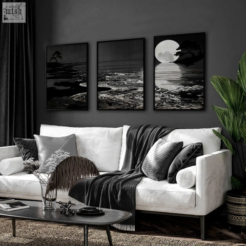 White sofa with black and gray pillows and dark gray blanket in living room featuring deep charcoal canvas pictures set