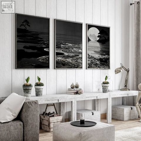 Three black and white canvas pictures with deep charcoal frames show serene coastal scenes for living room décor