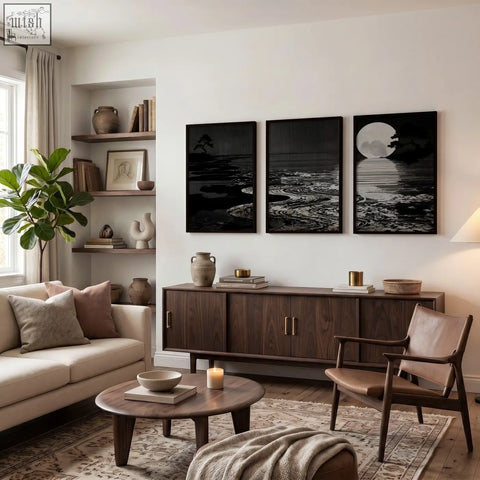 Dark wood sideboard with sleek metal handles and deep charcoal canvas pictures for living room Japandi moon landscape set of 3