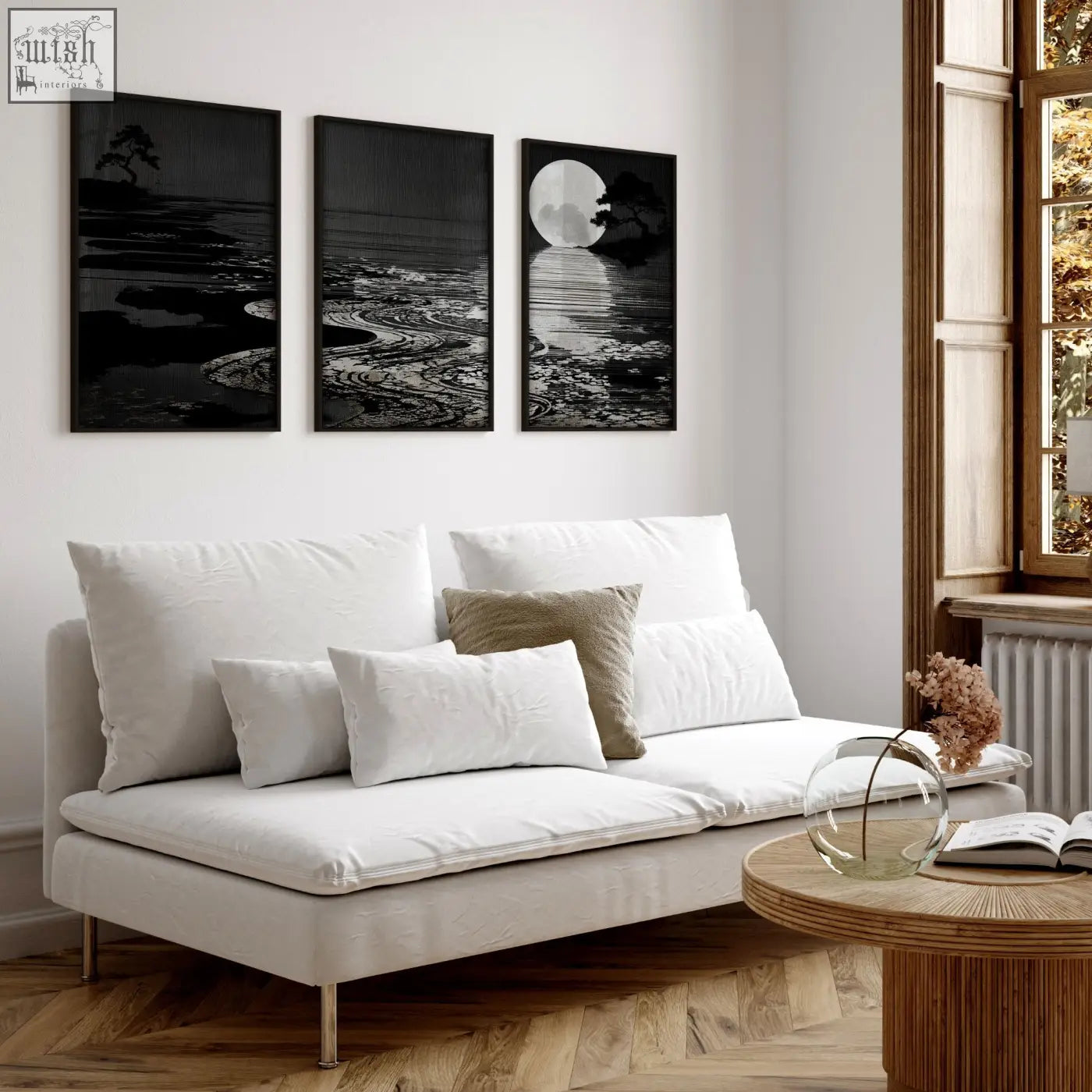 White upholstered sofa with metallic legs and cushions in living room with deep charcoal canvas pictures set of 3