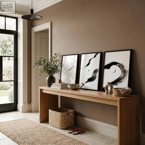 Minimalist wooden console table with natural finish and open storage below paired with black ink canvas zen wall art set