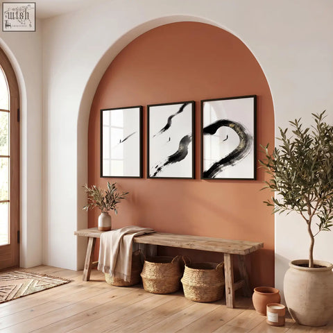 Three black ink canvas zen wall art prints with bold brushstroke designs hanging above a rustic wooden bench