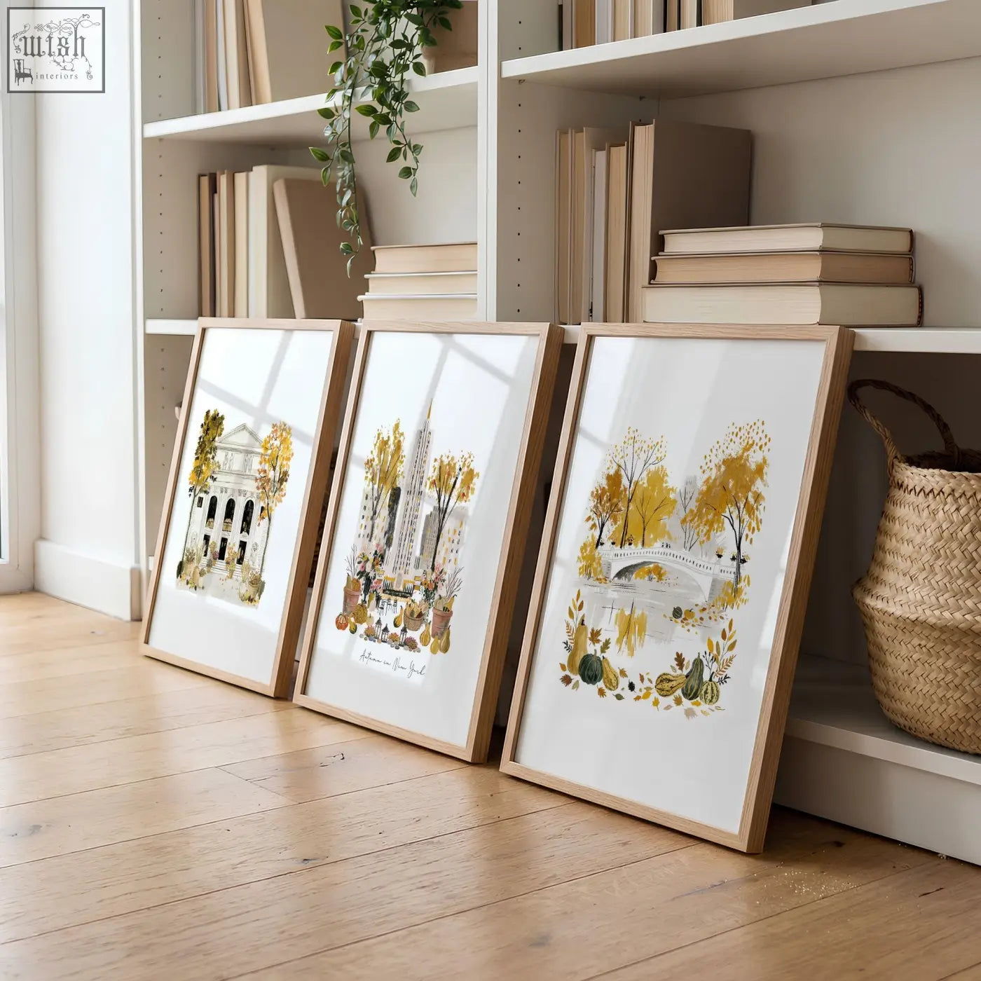 Three framed autumn-themed watercolor art prints with golden yellow foliage in light wood frames for living room wall art
