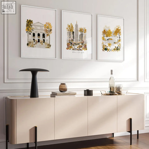 Cream-colored console table with sleek black legs paired with autumn in new york living room art prints wall art set of 3