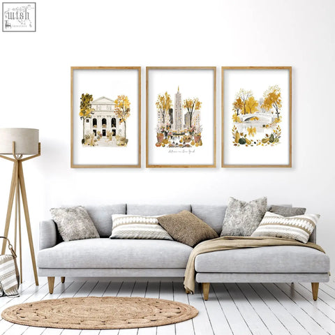 Three framed watercolor art prints with autumnal new york scenes in light wood frames for living room wall art