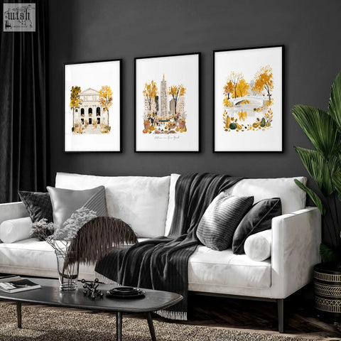 Three black framed autumn-themed art prints hang above a white sofa in a living room wall art set of 3