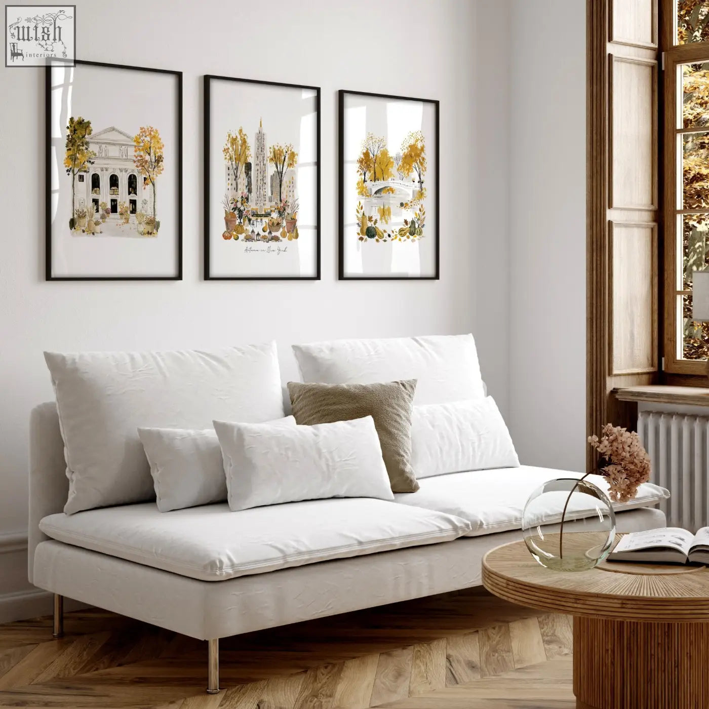 White upholstered sofa with metallic legs and cushions beneath autumn in new york living room art prints wall art set