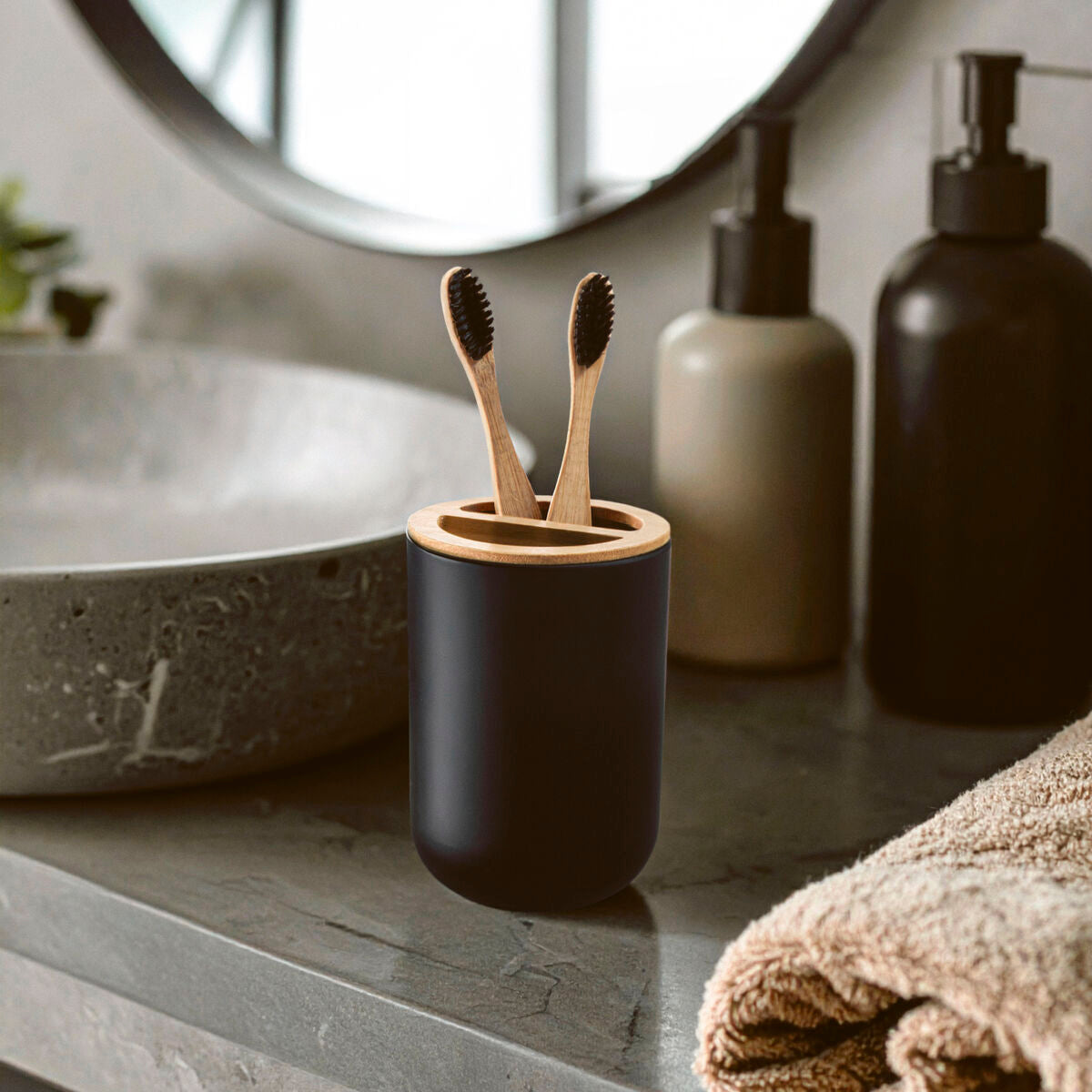 Canyon black toothbrush holder in black with light wood lid holding two bamboo toothbrushes for bathroom use