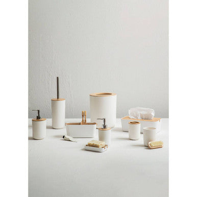 White soap dish made of ceramic with bamboo accents perfect for holding white soap in the bathroom