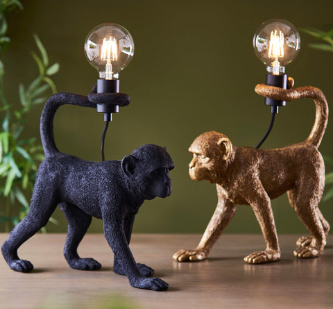 Two capuchin table lamps in matt black and gold finish with vintage bulbs held by articulated arms