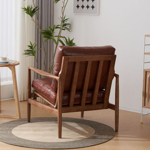Brown leather-upholstered cara bw002 armchair with wooden frame and vertical slats for stylish seating