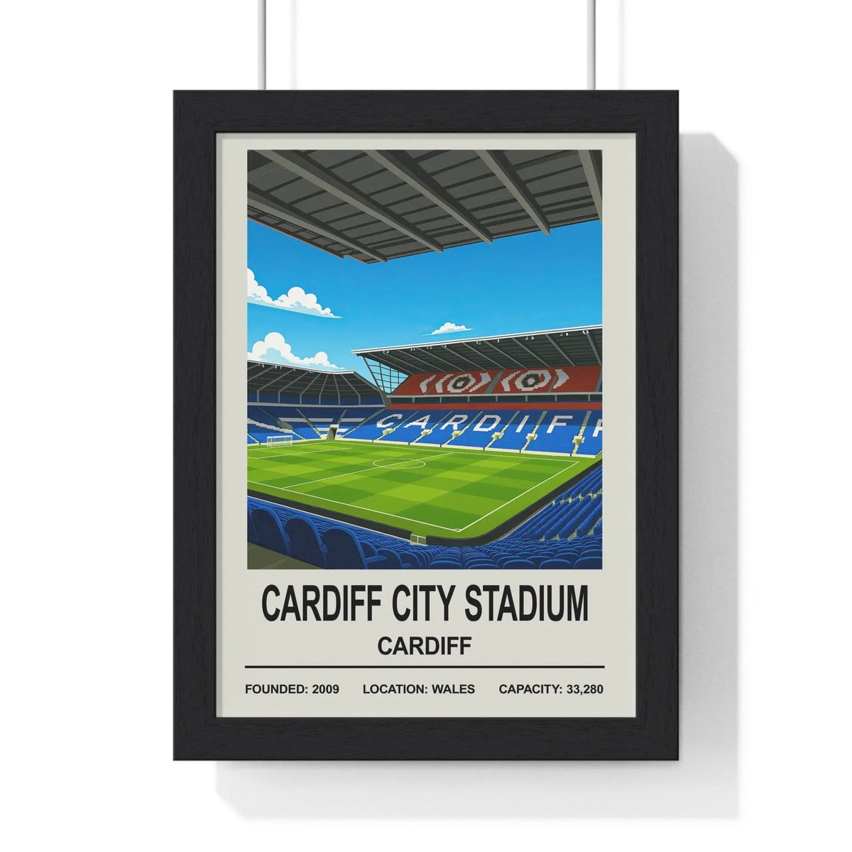 Black-framed poster print of cardiff city stadium illustration with blue seats green pitch and red and white banners