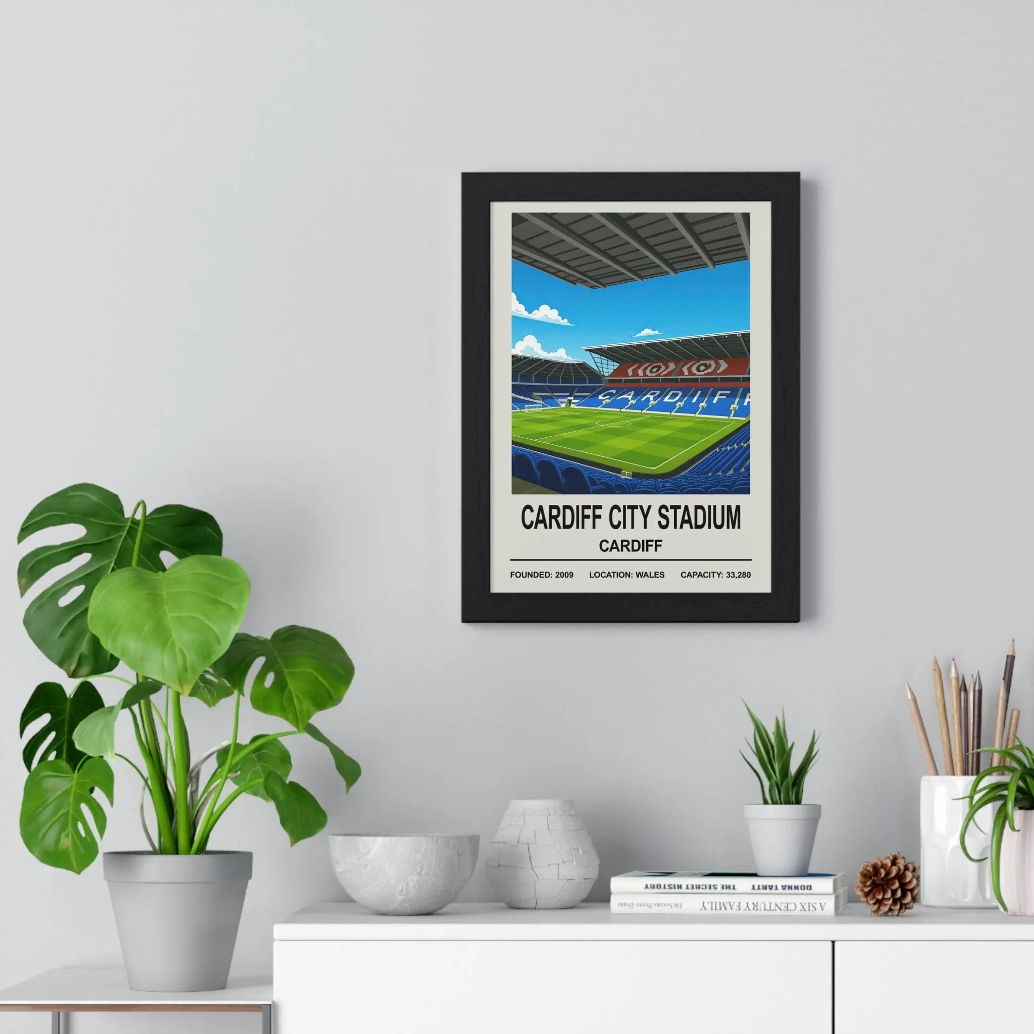 Black-framed Cardiff city stadium print featuring vibrant green turf, blue seats, and bold white text on cream background