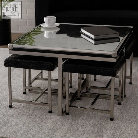 Modern nesting coffee table with glossy black glass top and chrome frame paired with black upholstered stools from carla set