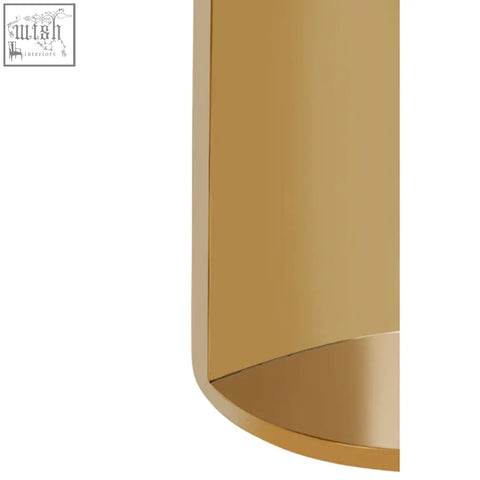 Gold-colored cylindrical wall sconce with smooth polished metallic finish near carlox gold and marble effect round side table
