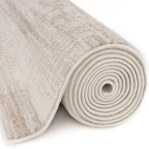 A rolled carmel cream-beige abstract rug with a textured woven pattern and soft pile
