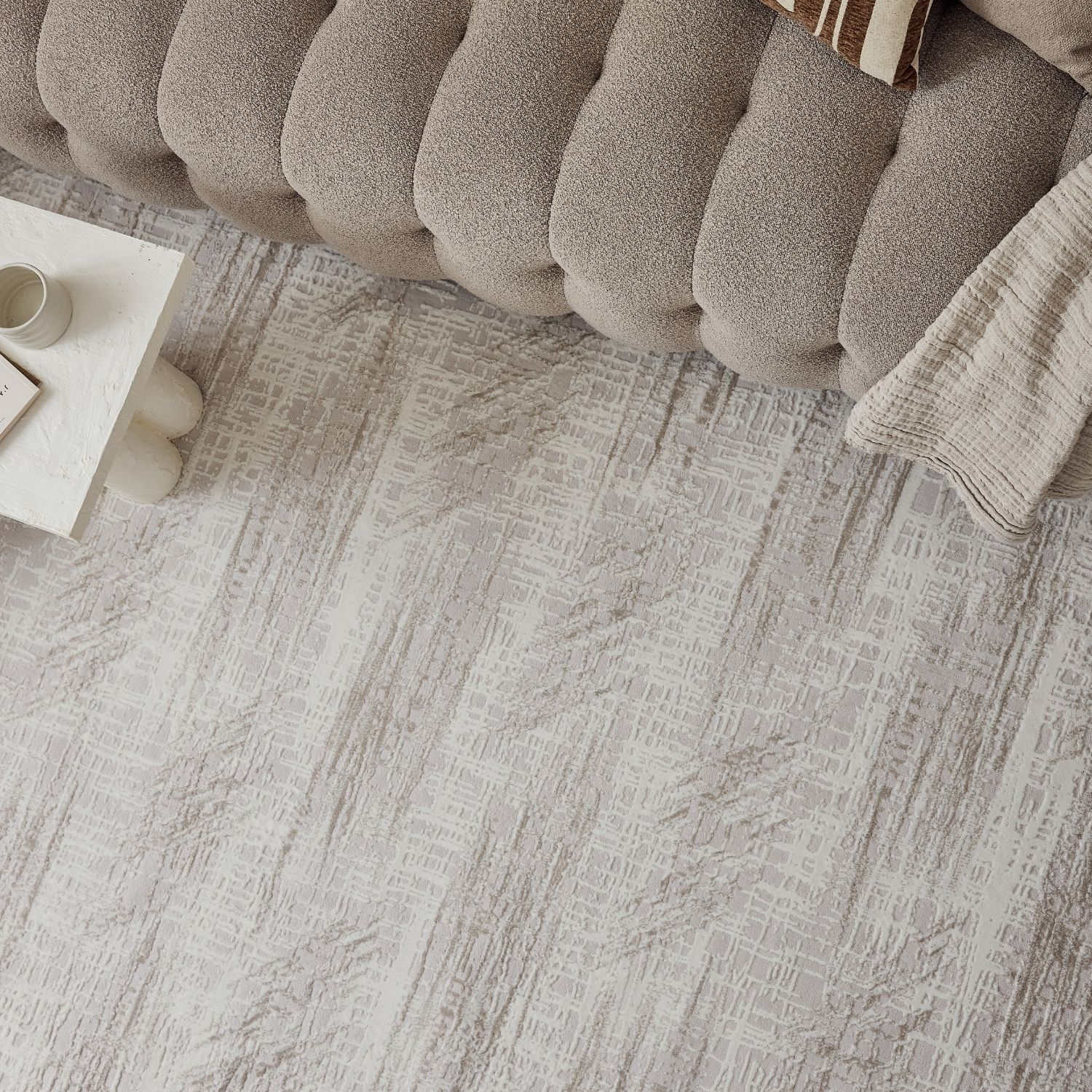 A textured gray abstract rug with a subtle geometric pattern perfect for adding style and comfort to any room