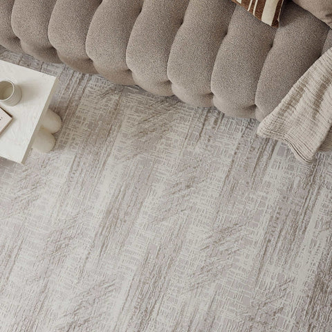 A textured gray abstract rug with a subtle geometric pattern perfect for adding style and comfort to any room