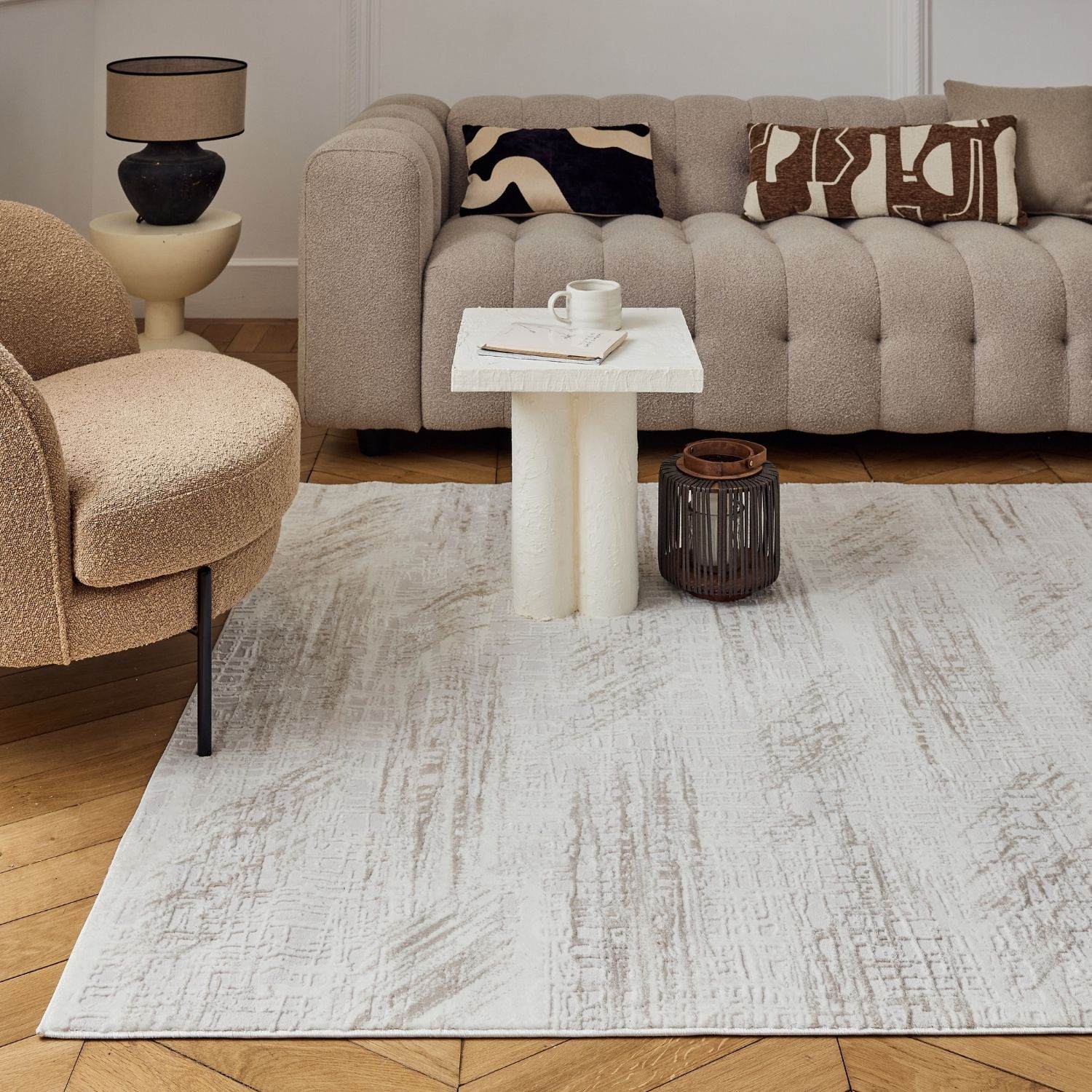 A light gray and white abstract rug with a textured, subtle distressed finish perfect for cozy living spaces