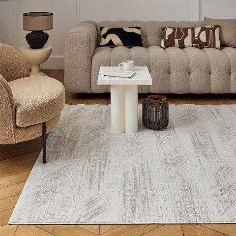A light gray and white abstract rug with a textured, subtle distressed finish perfect for cozy living spaces