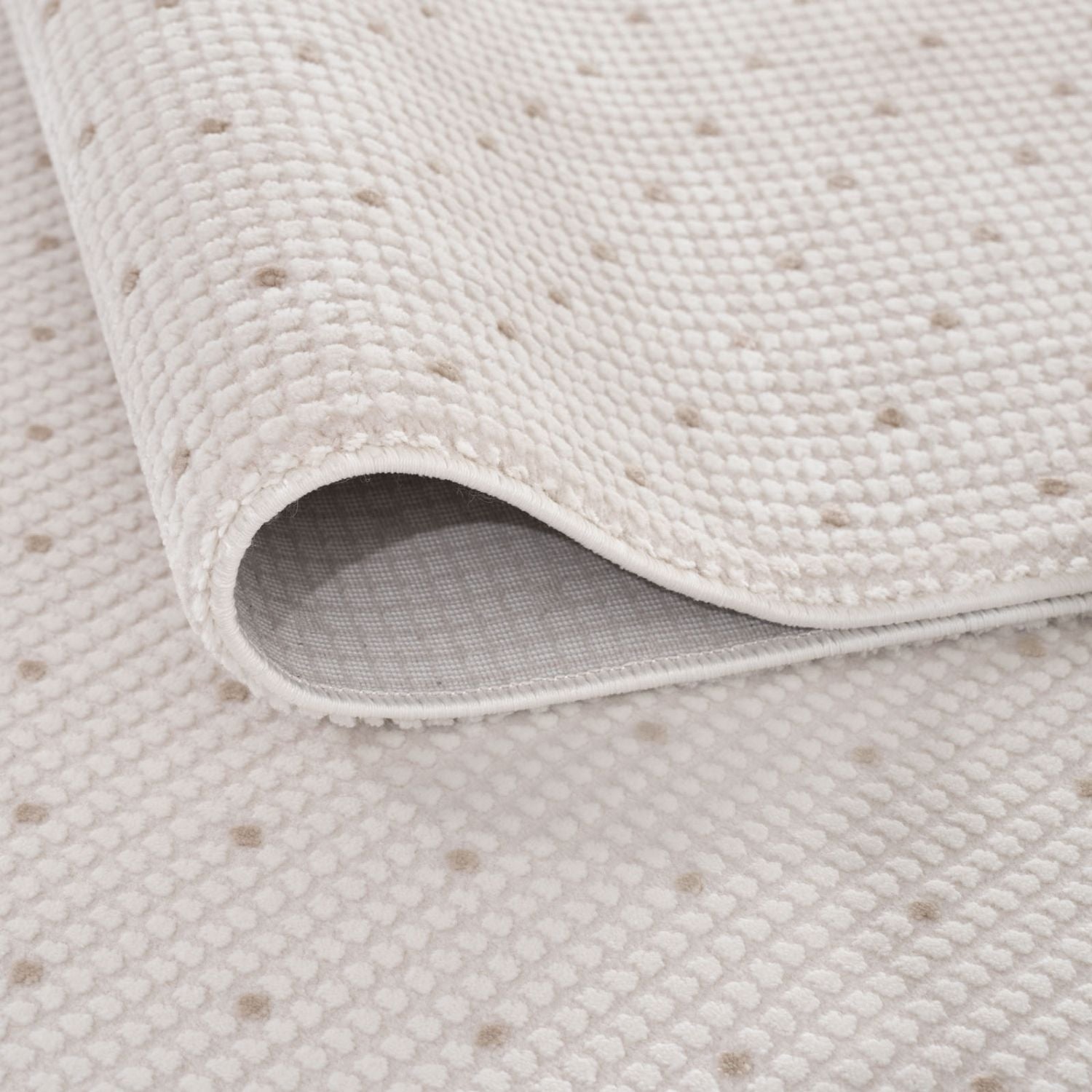 Off-white cream-beige dots rug with a soft woven texture and subtle dotted pattern perfect for bathroom use