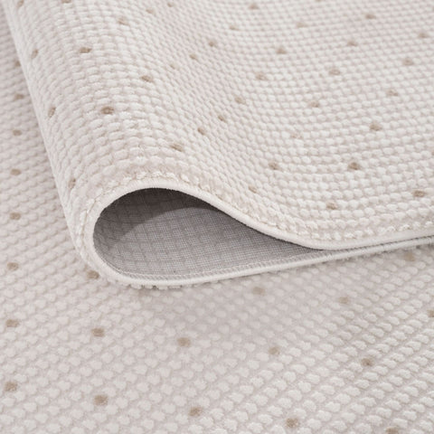 Off-white cream-beige dots rug with a soft woven texture and subtle dotted pattern perfect for bathroom use