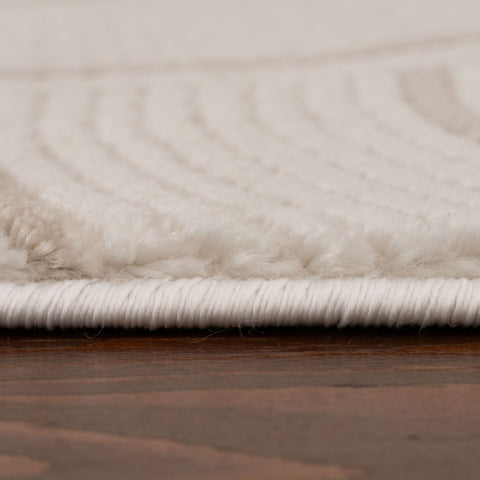 Cream-beige geometric rug with plush textured wave pattern and neatly bound white edge perfect for cozy spaces