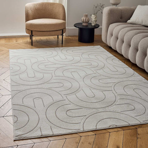 A light gray and cream beige geometric rug with a subtle raised pattern of interlocking curved lines perfect for any room
