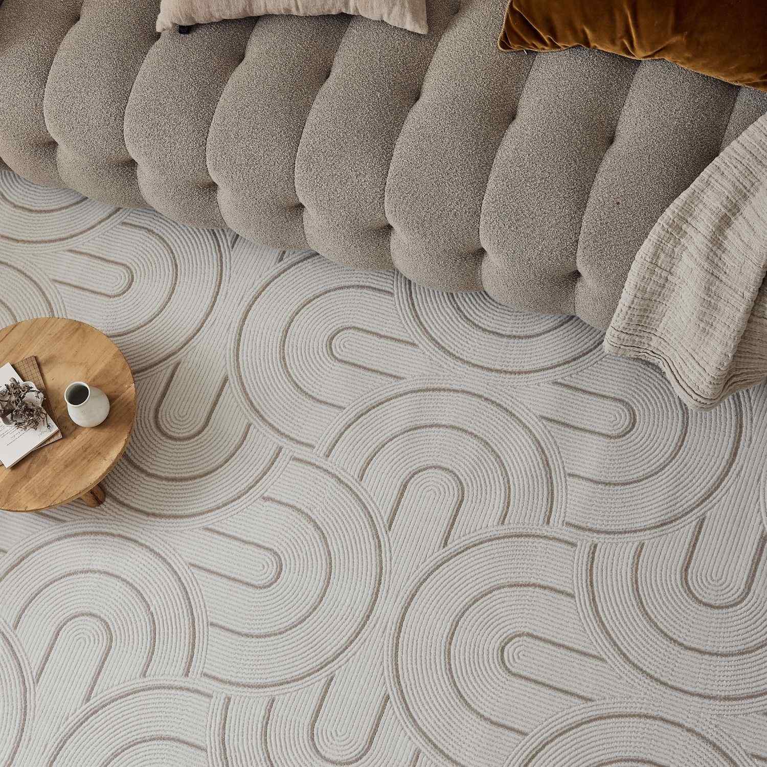 Beige geometric rug with subtle gray concentric wave patterns perfect for adding style to any room