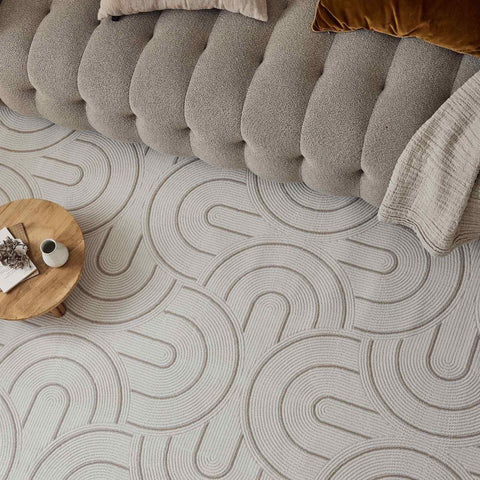 Beige geometric rug with subtle gray concentric wave patterns perfect for adding style to any room