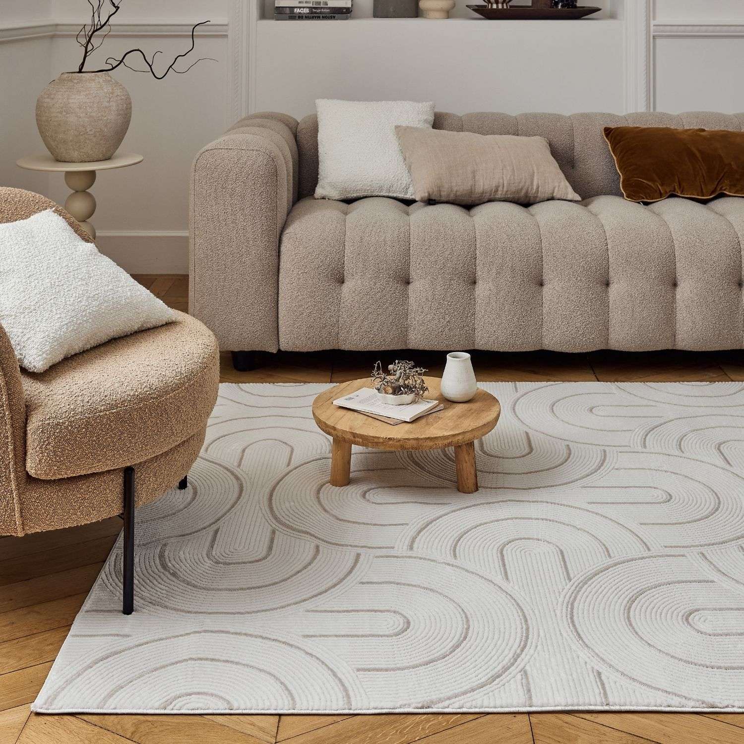 Beige tufted sofa with plush fabric and button detailing paired with carmel cream beige geometric rug 6070