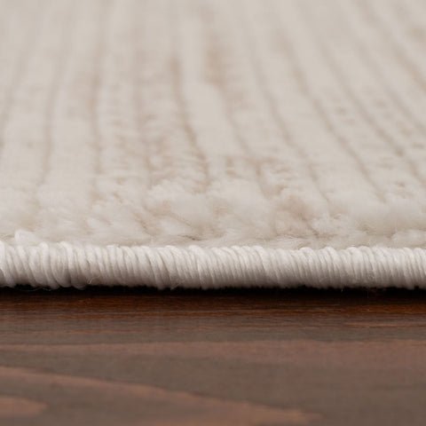 Cream beige striped rug with plush ribbed texture and white fringe perfect for cozy living spaces