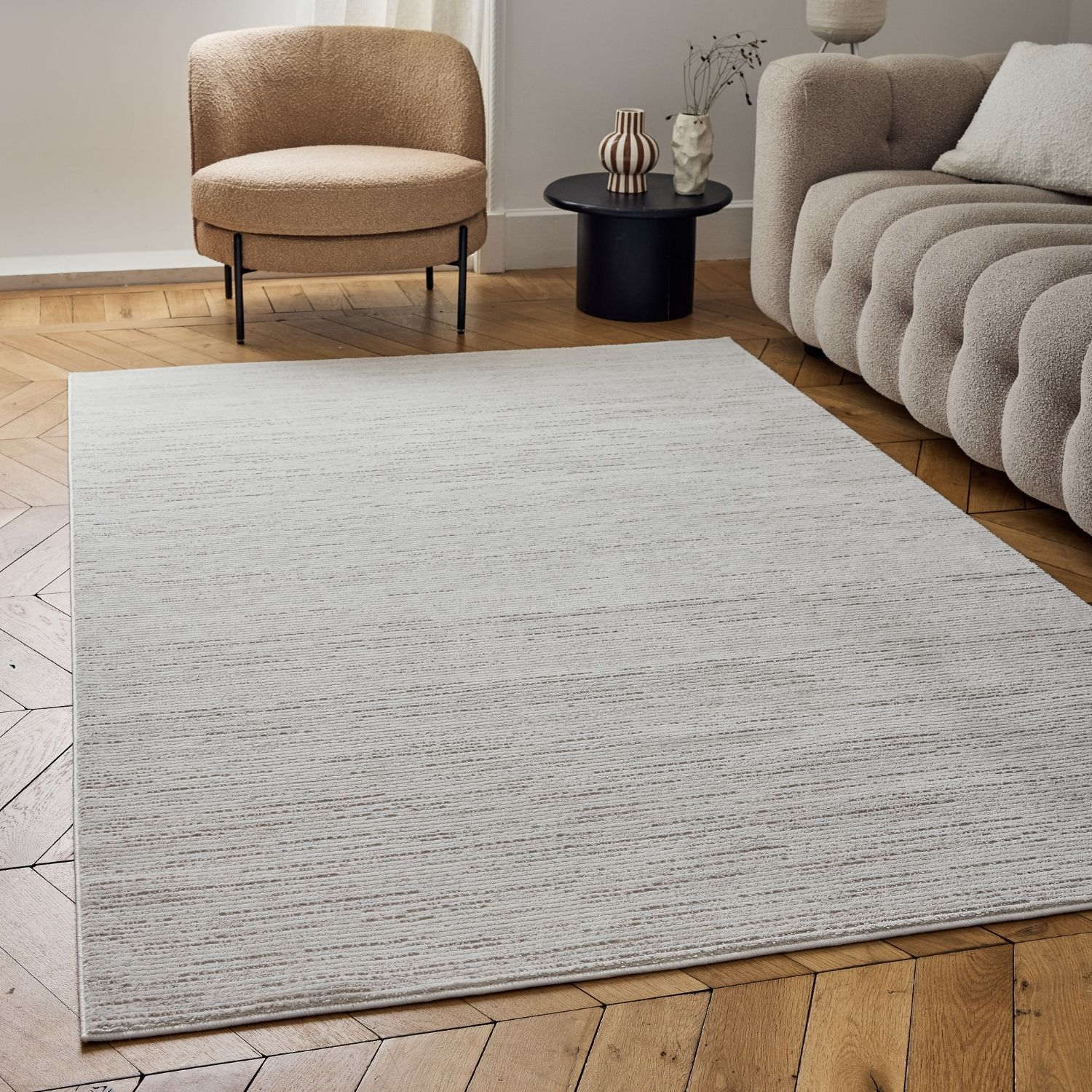 A rectangular carmel cream-beige striped rug with a subtle textured pattern and soft horizontal striations