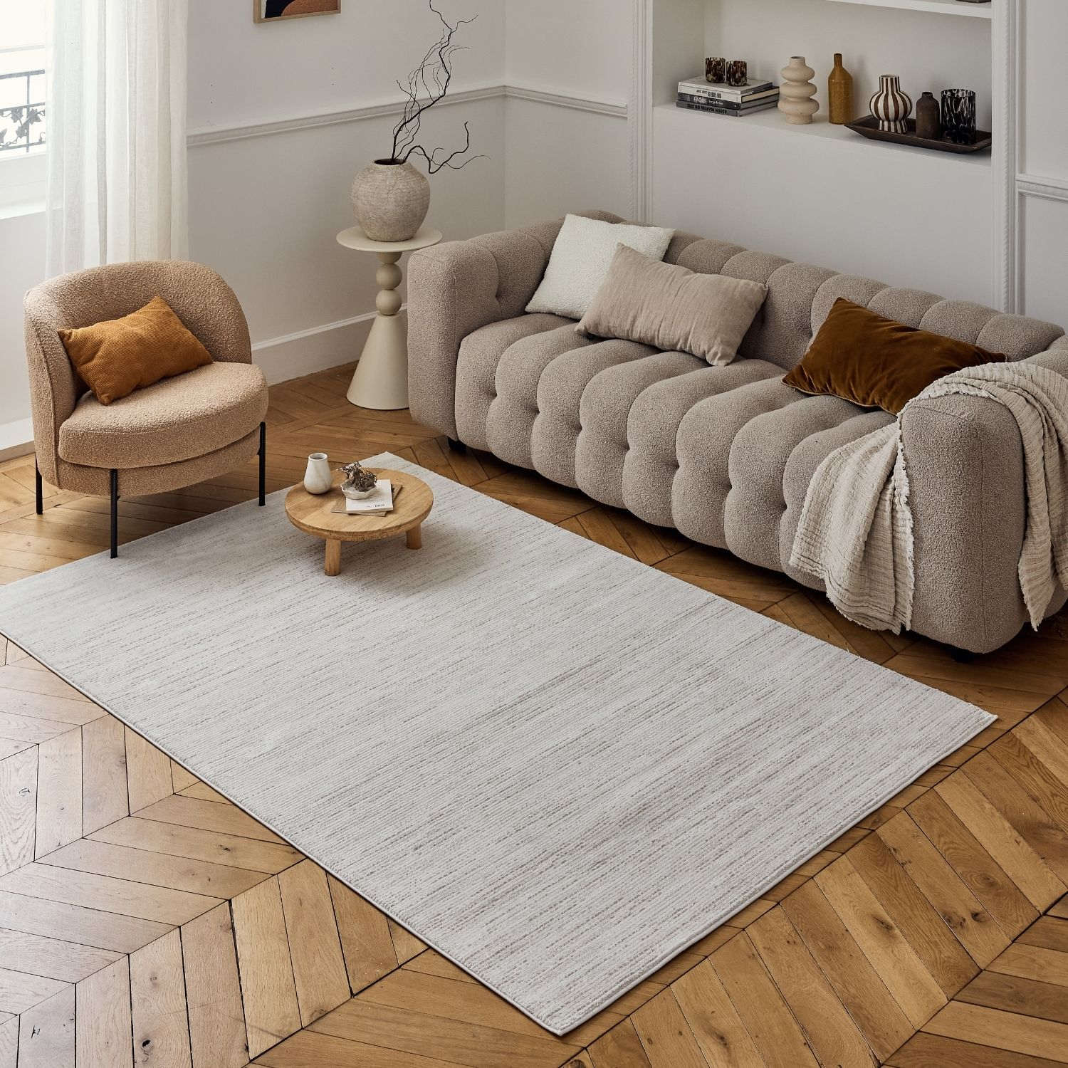 A soft light gray striped rug with subtle texture on wooden floor from carmel cream-beige striped rug 6010 collection