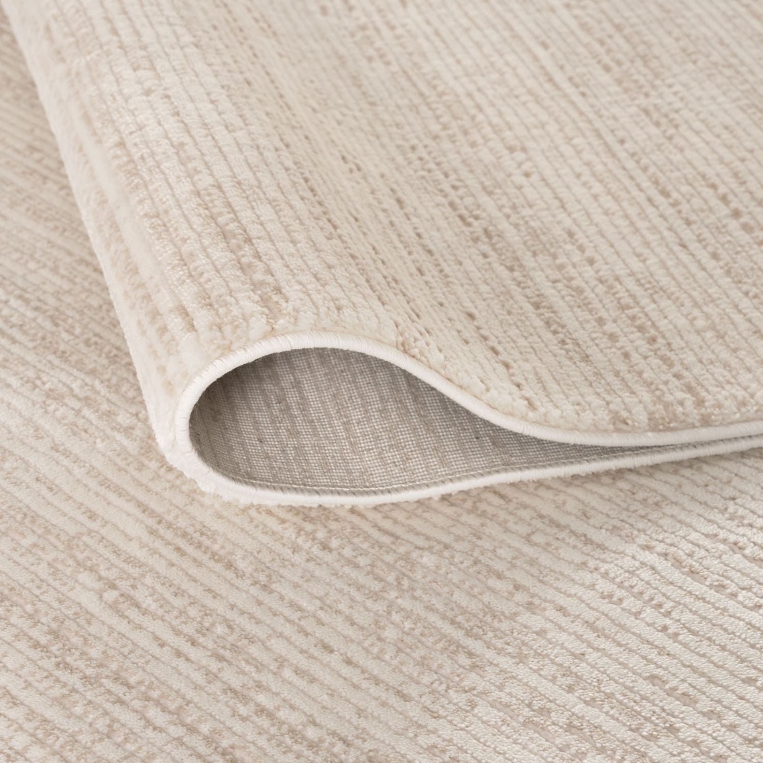 Beige textured striped rug with subtle woven pattern and soft plush surface perfect for cozy spaces