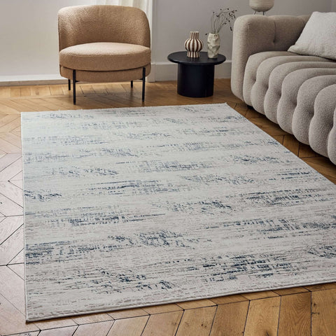 A modern rectangular abstract rug in cream and blue with a textured pattern perfect for any living space