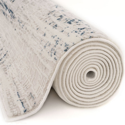 A rolled carmel cream-blue abstract rug with a subtle blue pattern and textured surface perfect for living rooms