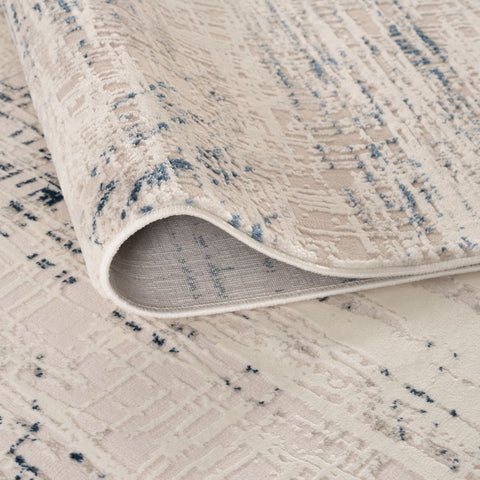A cream base abstract rug with blue abstract patterns and a soft pile finish perfect for cozy spaces