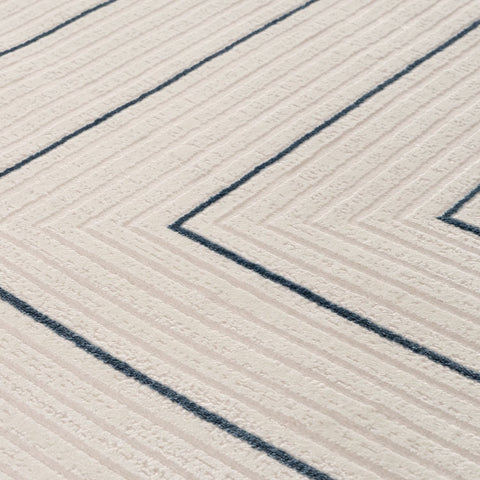 Cream-colored geometric rug with textured surface and bold navy blue chevron stripes for stylish decor