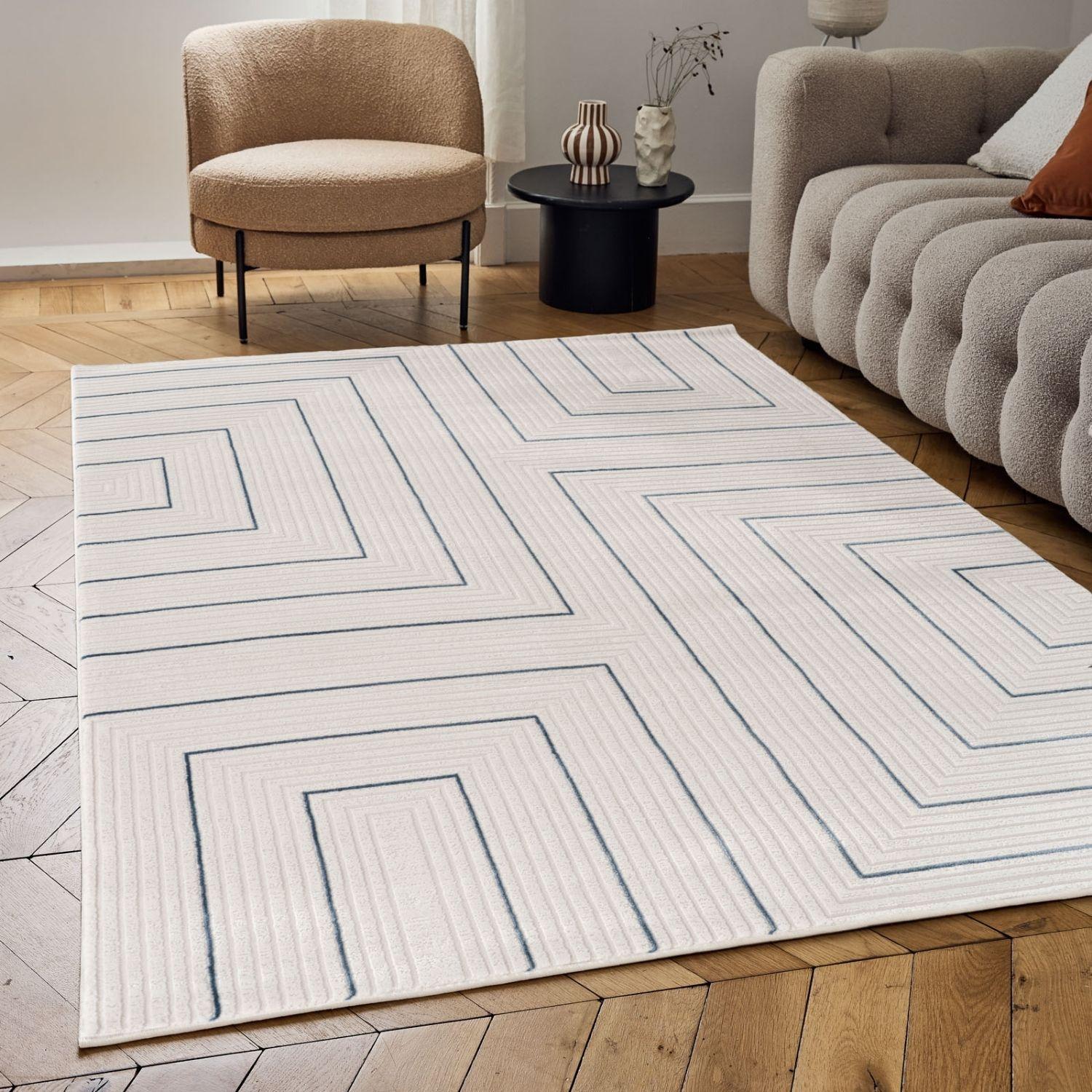 A modern geometric rug with a white base and navy blue linear patterns featuring a textured surface ideal for living spaces