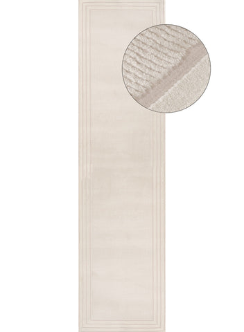 Beige rectangular bath mat with textured ribbed surface and subtle border detailing carmel cream bordered rug